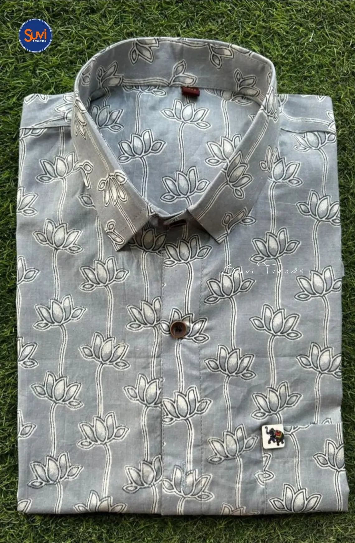 Introducing our Men's Lotus Printed Cotton Shirt in Grey. Made with pure cotton, this stylish shirt features a collared neck and half sleeves. Ideal for both casual and party wear, it's the perfect addition to any wardrobe. Buy now for a versatile and comfortable piece.