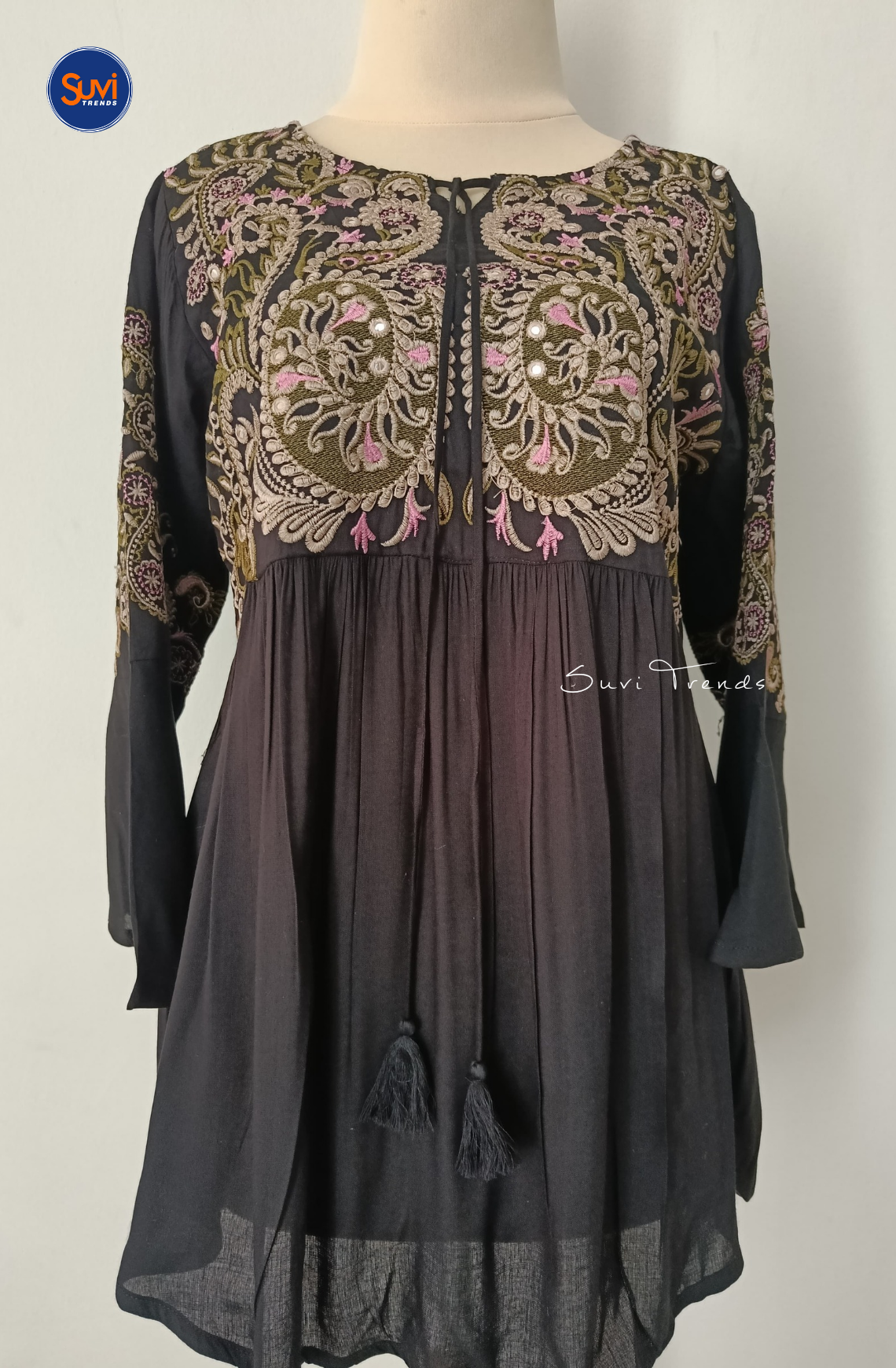 Elevate your ethnic wardrobe with our Embroidered Cotton Kurti with Tassels. Made of soft cotton with intricate embroidery, this short kurti features bell sleeves and a flattering peplum cut. Perfect for any occasion, get yours now at the best price!