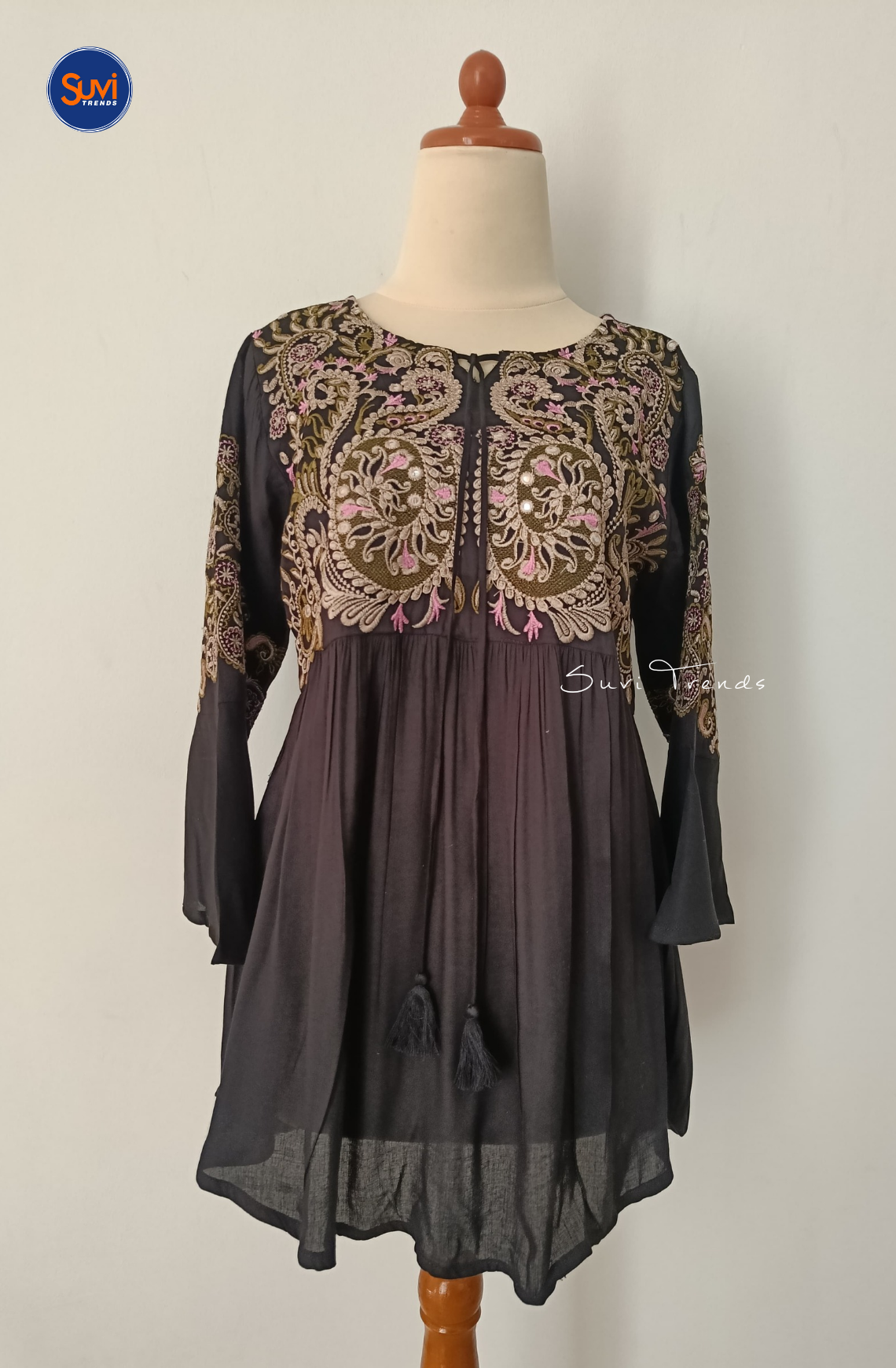 Elevate your ethnic wardrobe with our Embroidered Cotton Kurti with Tassels. Made of soft cotton with intricate embroidery, this short kurti features bell sleeves and a flattering peplum cut. Perfect for any occasion, get yours now at the best price!