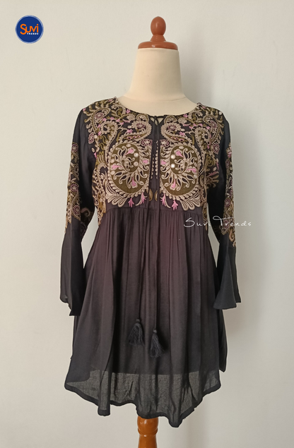Elevate your ethnic wardrobe with our Embroidered Cotton Kurti with Tassels. Made of soft cotton with intricate embroidery, this short kurti features bell sleeves and a flattering peplum cut. Perfect for any occasion, get yours now at the best price!