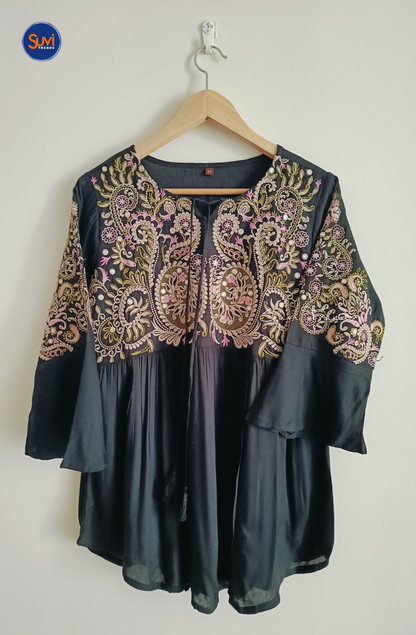 Elevate your ethnic wardrobe with our Embroidered Cotton Kurti with Tassels. Made of soft cotton with intricate embroidery, this short kurti features bell sleeves and a flattering peplum cut. Perfect for any occasion, get yours now at the best price!